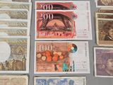several different bank notes are laid out on a table