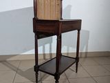 a small table with a wicker chair on it