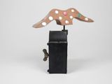 a wooden sculpture of a horse on top of a black box