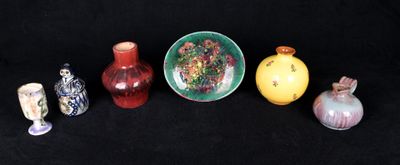 cinq vases différents et un bol sur fond noir