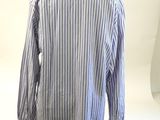 a white and blue striped shirt on a mannequin stand