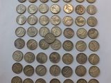 a pile of coins sitting on top of a white surface
