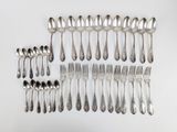 a lot of silver spoons and forks on the table