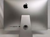 a silver apple computer sitting on a white table