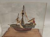 a small model of a ship in a glass case