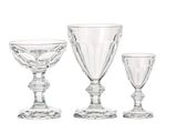 three wine glasses sitting next to each other on a white surface