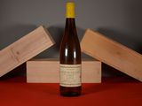 a bottle of wine sitting on a table next to a wooden box
