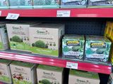 many boxes of green tea on the shelf in the store