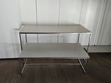 two tiered table with a white top in a room