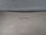 the back of a gray bag with a zipper on it