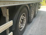 a green and yellow semi truck parked on the side of the road