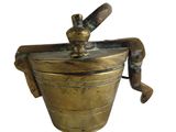 antique brass ice bucket with a wooden handle on a white background