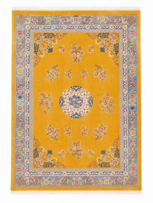 a yellow rug with a floral design on the center