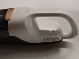 a black and white hand held vacuum cleaner on a table