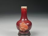 chinese red and white vase on stand on grey background