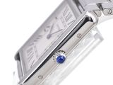 a close up of a wrist watch with a blue stone