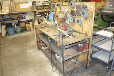 a workbench that has a lot of tools on it