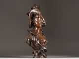 bronze statue of a woman with a hat and a feather on her head