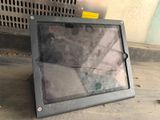 a picture of a broken tablet computer sitting on the ground