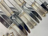 a lot of silverware on a table with a spoon and knife