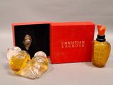 two bottles of perfume sitting next to each other in a red box