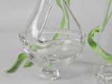 a glass vase with a plant in it next to a glass vase with a plant inside of it