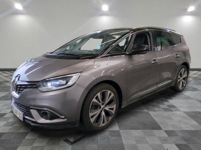 the grey car is parked on a checkered floor in the garage