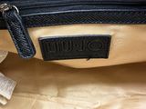 the inside of a black and tan bag with a black label