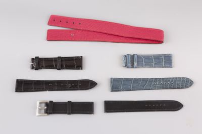 several different types of watches are laid out on a white surface