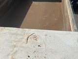a dirty truck that is parked on the side of the road