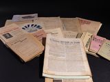 a pile of old newspapers sitting on a table
