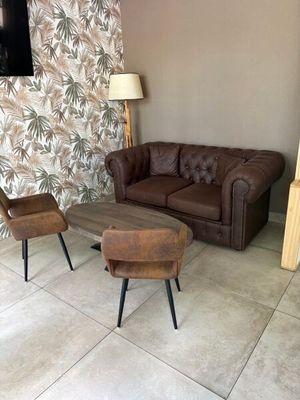 two chairs and a couch in a living room