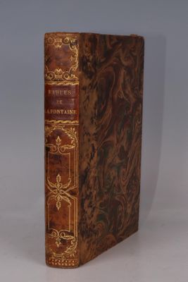 an old book sitting on top of a white table