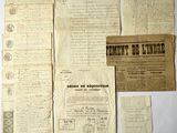 some old papers are laying on top of a white table