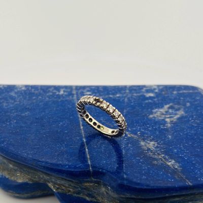 a close up of a silver ring on a blue stone