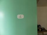 a picture of a room with a green wall and a clock on the wall