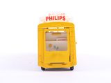 a small yellow machine with a sign on top of it