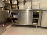 a large stainless steel kitchen with a lot of dishes on the counter