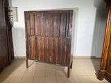 a wooden cabinet in the corner of a room