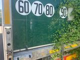 a truck that has vines growing on the side of it