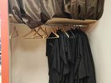 an image of a closet with clothes on hangers