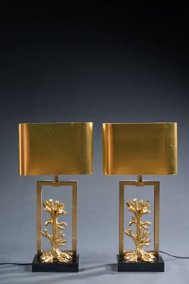 pair of brass table lamps with flowers and leaves on them