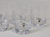 four glasses that are sitting on a table