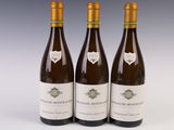 three bottles of wine sitting on top of a white table