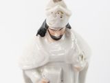 a figurine of a woman in a white dress