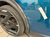 a close up of a blue car with a sticker on it
