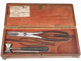 une boîte en bois contenant des outils, posée sur une surface blanche