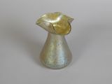 a silver vase with a yellow flower inside of it