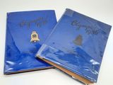 two blue book covers with gold lettering and a bell on them