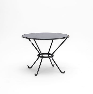 a black table with a metal base and a glass top